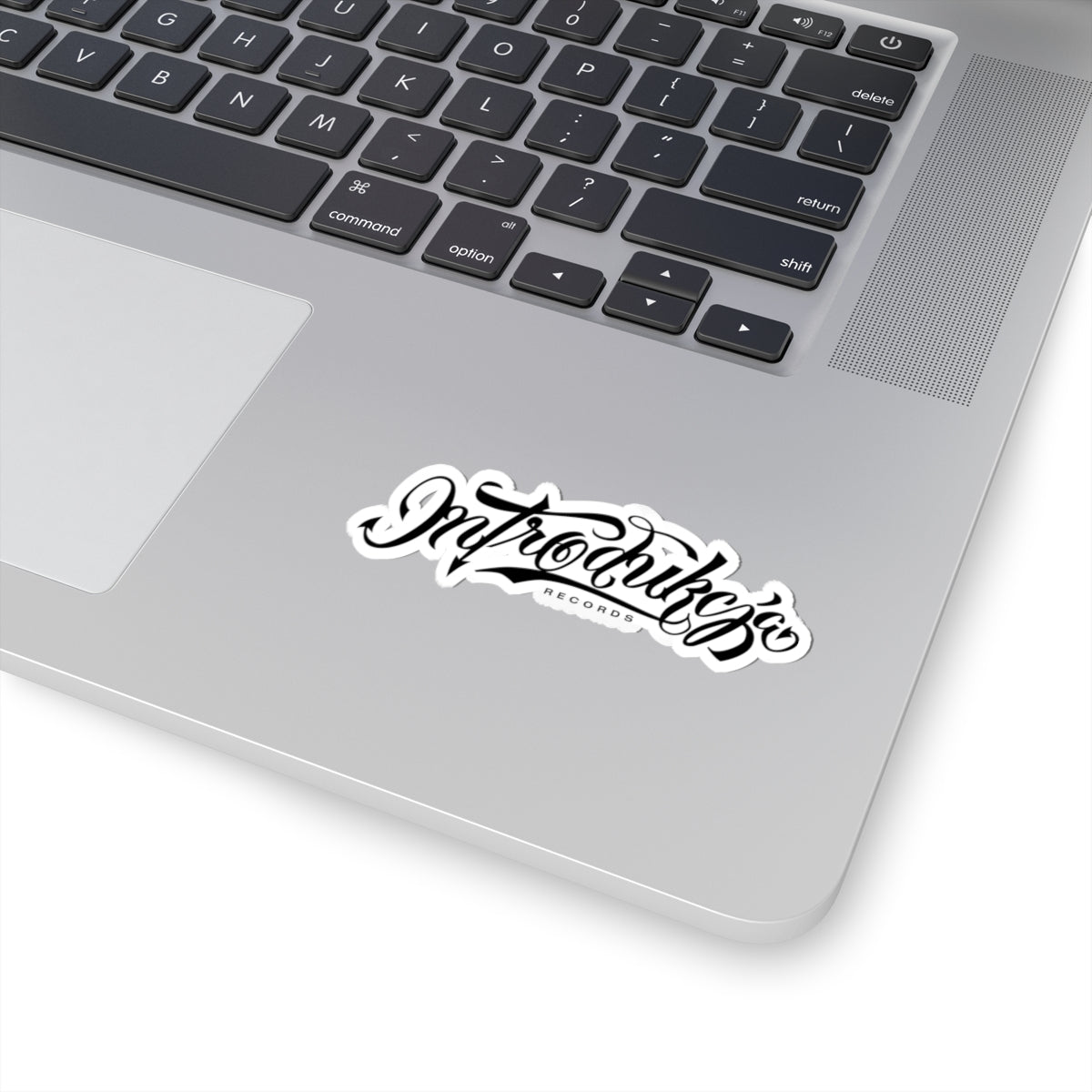 Laptop with a 'Introverts' sticker on the palm rest area