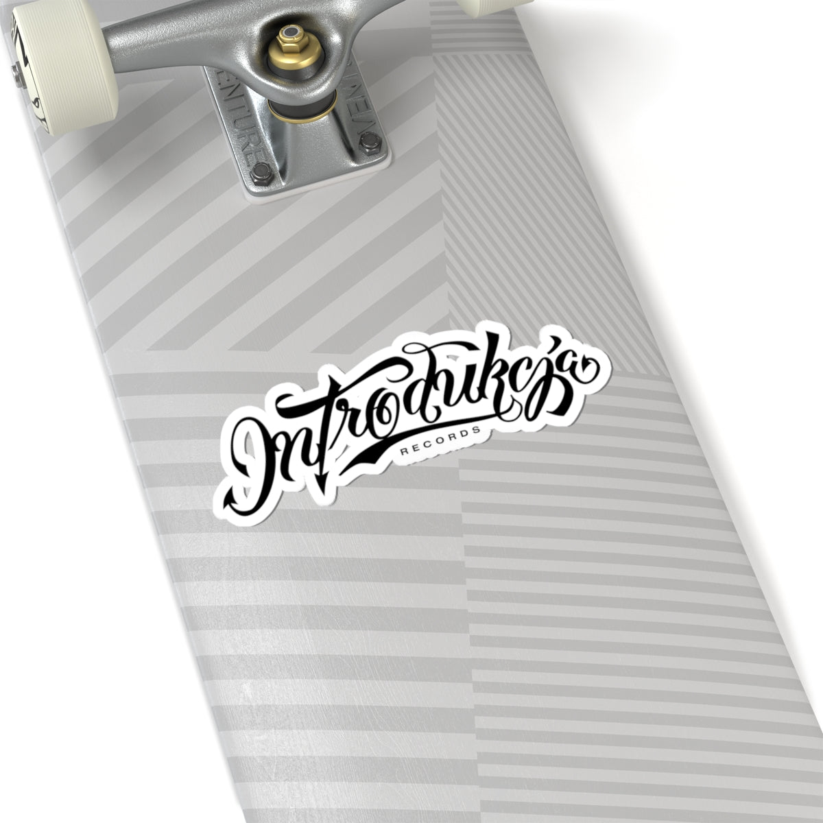 Skateboard deck with a 'Intro Tracks Records' sticker on a white background